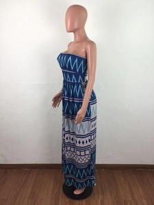 Detail of blue geometric print maxi dress showing the strapless neckline and floral patterns