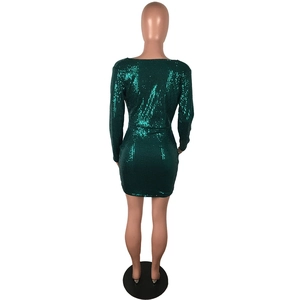 Detailed back view of deep green sequin dress with V-neck cutout and shimmering finish