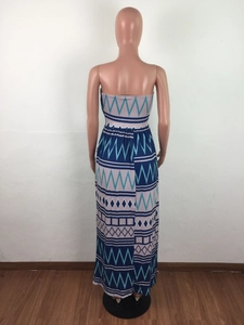 Detail of a strapless maxi dress featuring a blue geometric print and a slim fit waist