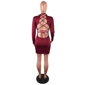 Back detail of burgundy backless dress featuring elegant crisscross bandage ties