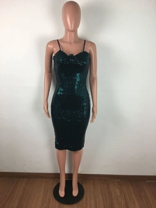 Close-up of sparkling dark green sequins and heart-shaped neckline on a slim fit dress
