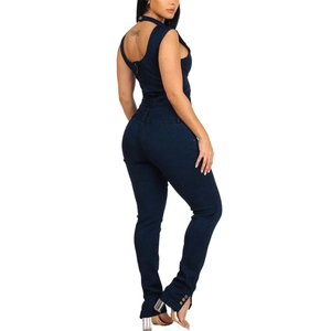 Slim fit dark blue denim jumpsuit featuring a halter neck and side buttons on the ankles