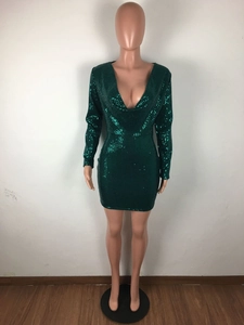 Detailed view of dark green sequin mini dress with deep V-neck and sparkling metallic finish
