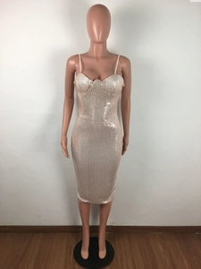 Close-up of champagne gold sequined bodycon dress with sleek spaghetti straps