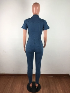 Detail view of the back of a slim fit deep blue denim jumpsuit with waist stitching and pockets