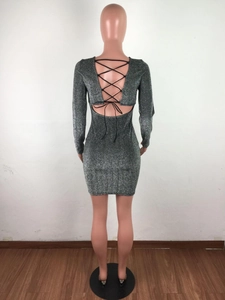 Detail of silver sequin bodycon dress featuring backless design with black crossover straps