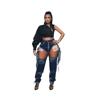 Fashionable women street style set with black cropped jacket and cutout sequin denim jeans
