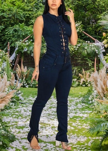 Detail of metal eyelet lace-up front and slim fit design on dark blue denim jumpsuit