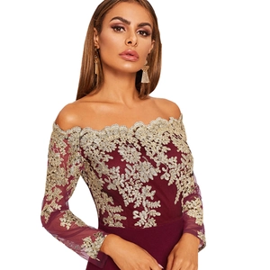 Détail de la robe bordeaux à épaules dénudées avec broderie de dentelle dorée
