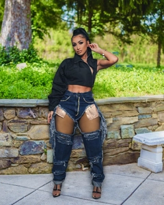 Fashionable blue high waist ripped jeans featuring gold sequin lining and fringe details
