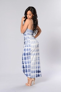 Detailed close-up of blue tie-dye printed dress with slit hem and textured fabric