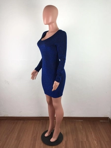 Detail of navy blue glitter fabric on a tight long sleeve V-neck backless mini dress