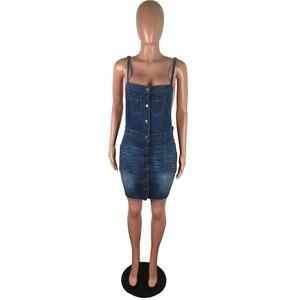 Detailed view of dark blue washed denim dress with metal buttons and frayed hem edge