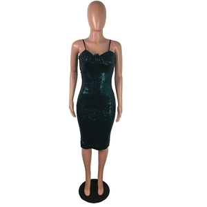 Close-up of dark green sequin dress fabric showing slim fit cut and sweetheart neckline