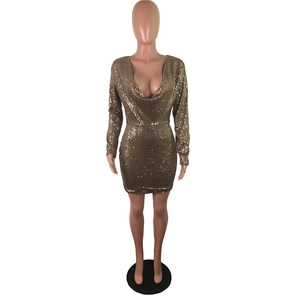 Detail view of gold sequin mini dress featuring draped V-neck and sparkling fabric texture