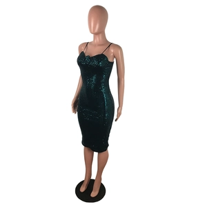 Close-up of a dark green sequined bodycon midi dress featuring shiny reflective textures
