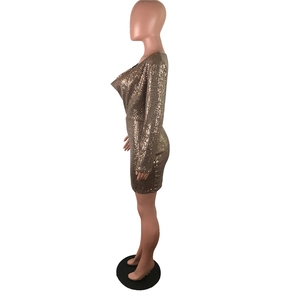 Detailed side view of bronze gold sequin dress with deep V-neck and long sleeves