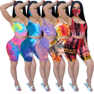 Selection of vibrant tie-dye activewear sets with crop top, shorts, and matching mask