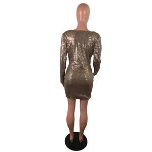 Detailed view of the sparkling champagne gold sequins on a long sleeve party dress