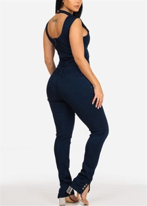Detail view of back zipper and side gold buttons on slim fit denim jumpsuit