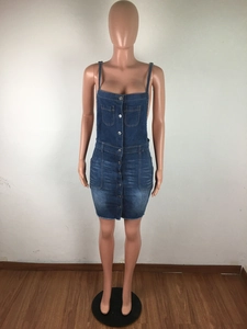 Detail of washed denim mini dress featuring metallic buttons and frayed hemline finish