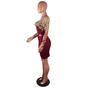 Détail de la broderie florale dorée sur une robe de soirée bordeaux à épaules dénudées