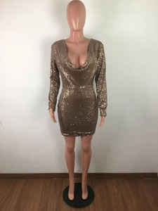 Detailed view of shimmering gold sequins on long-sleeve mini dress with V-neckline