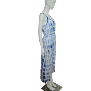 Detail of blue and white tie-dye dress featuring a deep V-neck and slim adjustable straps
