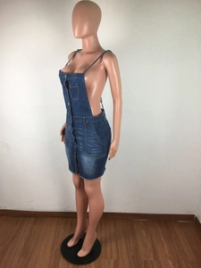 Detail of dark blue denim mini dress featuring front buttons and frayed hemline details