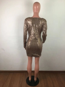 Close-up detail of high-density gold sequins on back of bodycon mini dress