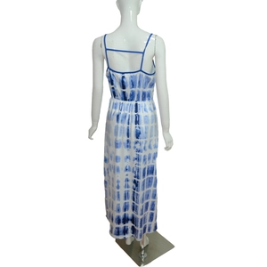 Detail of summer tie-dye maxi dress featuring a low back design with cross straps