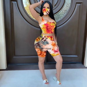 Three-piece vibrant tie-dye loungewear set featuring crop top, bike shorts and face mask