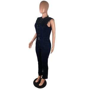Detail of dark blue slim fit denim jumpsuit with lace-up eyelet design and sleeveless cut