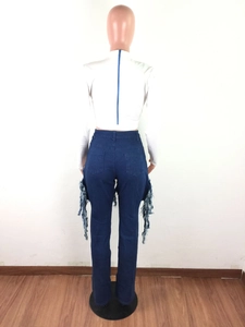 Detail showing the back blue zipper on white top and fringe denim pants on a mannequin