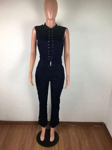 Detail of cross-lacing design and silver metal buttons on a slim-fit blue denim jumpsuit