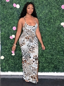 Detail of slim leopard print maxi dress with spaghetti straps against floral background