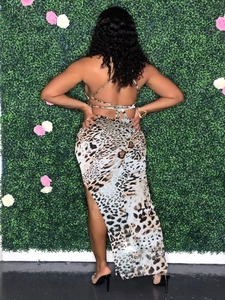 Detail of leopard print maxi dress with halter backless tie and high side slit