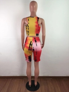 Back view of a women's tie-dye athletic set featuring a crop top and biker shorts