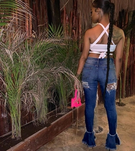 Deep blue high-waisted flared jeans featuring distressed knees and frayed bell bottom hems