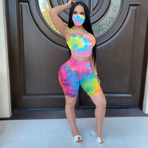 Detail view of colorful tie-dye patterns on women's vest and shorts with matching mask