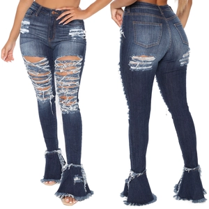 Detailed macro view of distressed ripped denim jeans with flared ruffle fringe hemline