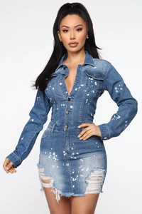Detail of distressed denim mini dress featuring paint splatter and front button closure