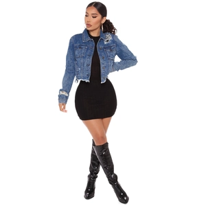 Cropped denim jacket with distressed ripped details and raw fringe hem in blue wash