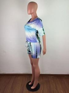 Detail view of tie-dye lounge set featuring side stripes and drawstring waistband