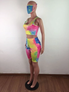 Detailed close-up of vibrant tie-dye pattern on three-piece women's athletic set with mask