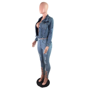 Detailed side view of vintage distressed denim jacket with fringe and ripped skinny jeans