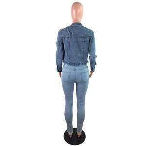 Rear view of cropped denim jacket with distressed holes and frayed tassels hem