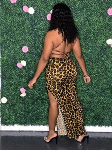 Detail of sexy leopard print maxi dress with open back tie design and high side slit