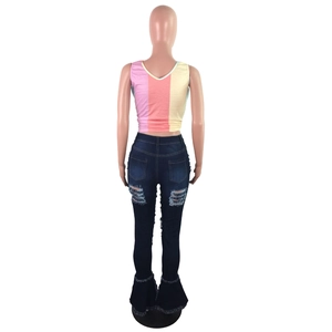 Detailed back view of dark blue flare jeans with distressed rips and frayed hem details