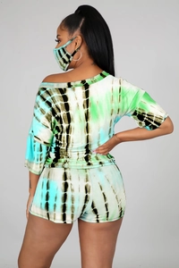 Detail view of women's three-piece tie-dye set showing side cut and blue-green pattern